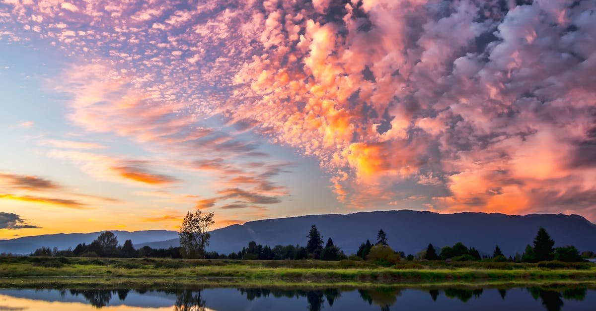 Captivating sunset with vibrant clouds and serene reflections over Pitt Meadows, BC.